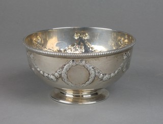 A Victorian repousse silver sugar bowl with floral scrolls and swags and vacant cartouche London 1866, 192 grams 
