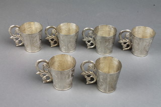 A set of 6 Continental silver cup holders with floral decoration and scroll handles, 290 grams