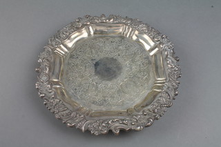 A silver card tray with floral and scroll rim and chased scroll decoration on shell feet, Sheffield 1909, 436 grams