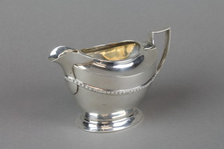 An Art Deco silver cream jug with strap work decoration, London 1927, approx. 206 grams