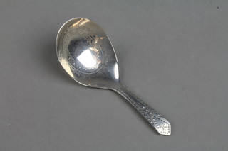A Georgian silver caddy spoon with simple bright cut decoration 