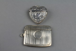 A silver engine turned vesta, Chester 1912 and a silver heart shaped box 