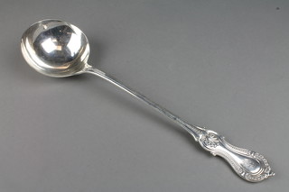 A Victorian silver ladle with fancy handle and chased monogram, London 1897, 298 grams