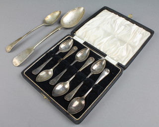 A set of 6 silver cased teaspoons, a Victorian silver table spoon and a Georgian silver dessert spoon, 178 grams