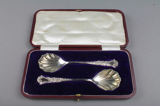 A pair of silver plated cased serving spoons with shell bowls 