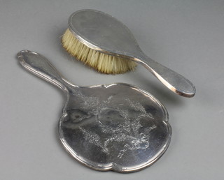 A silver backed dressing table mirror decorated with swags, scrolls and festoons, Birmingham 1915, a ditto engine turned hairbrush