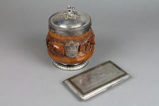 An early 20th Century silver plated mounted biscuit barrel with acorn finial, the carved body with scrolling acorns and engraved cartouche 6" together with a plated engraved cigarette case 