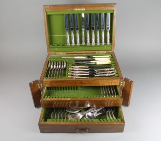 An oak canteen containing a quantity of plated Kings pattern cutlery 