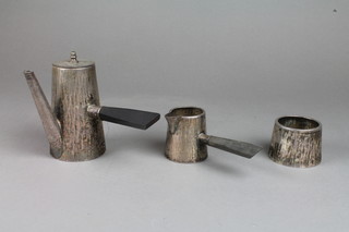 An Art Deco silver plated bachelor's tea set with hammer pattern decoration and ebony mounts