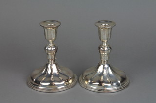 A pair of Continental silver weighted candlesticks with wide splayed bases 6"
