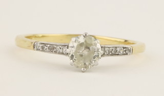 A gold single stone diamond ring with diamond shoulders, approx 0.65ct, size R 1/2