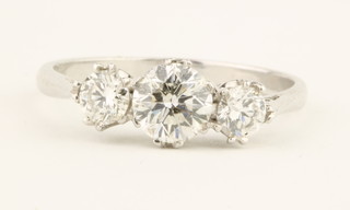 An 18ct white gold 3 stone diamond ring, the claw set stones approx 1.15ct, size M 1/2