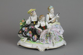 An early 20th Century figure group of 3 ladies on a raised Rococo base 11" 