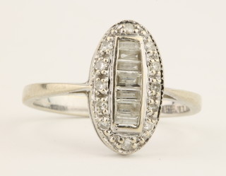 An 18ct white gold fancy diamond ring set with baguette and brilliant cut stones, size N 