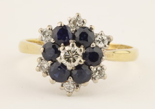 An 18ct yellow gold sapphire and diamond cluster ring, the 6 sapphires approx. 1/2ct surrounded by 6 brilliant cut diamonds approx. 1/2ct, size Q