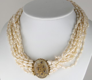 A 12 strand cultured pearl necklace, the 9ct clasp with hardstone and sapphire mounts