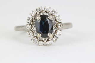 An 18ct diamond and sapphire cluster ring, the centre stone approx 1.25ct surrounded by 28 brilliant cut diamonds, size P