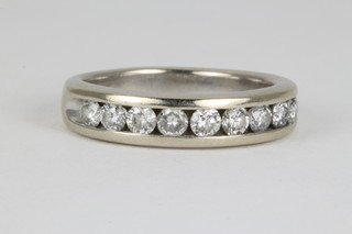 A 14ct white gold channel set 9 stone diamond ring, size N, approx 3/4ct together with EGL certificate 