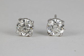 A pair of diamond ear studs in 14ct white gold claw settings, approx. 1.0ct total