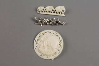 2 carved ivory brooches and a silver ditto 