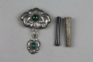 A Continental silver mounted cheroot holder and repousse drop brooch with cabouchon mounts 