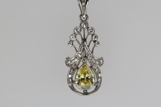 A white gold diamond open pendant, set with a pear cut canary centre stone approx. 1.2ct, surrounded by brilliant cut diamonds on an 18ct white gold chain (possibly colour enhanced) 