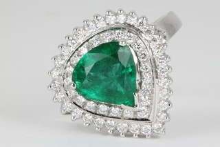 An 18ct white gold emerald and diamond pear shaped ring, the centre stone approx 2.8ct surrounded by 22 brilliant cut diamonds, approx. .75ct, size Q