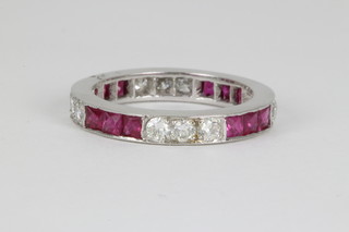 A white gold brilliant cut diamond and princess cut ruby full eternity ring, size M