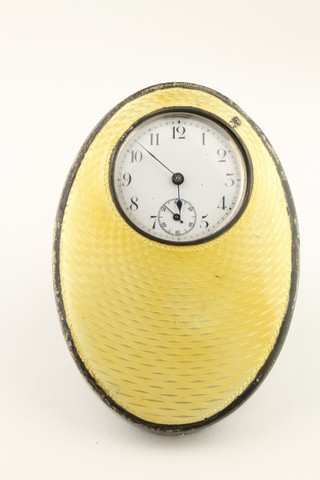 A 1930's oval silver and yellow guilloche enamel table timepiece, Birmingham 1938 
