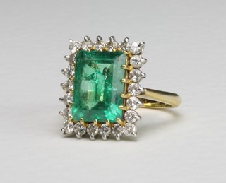 An 18ct yellow gold emerald and diamond cluster ring, the centre stone approx. 3ct surrounded by 22 brilliant cut diamonds, size M