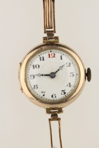 A lady's 9ct gold wristwatch with enamelled dial and red 12 