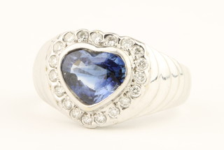 An 18ct white gold heart shaped sapphire and diamond ring, the centre stone approx. 2ct surrounded by 19 brilliant cut diamonds, size L 1/2