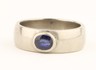 An 18ct white gold sapphire rub-over set ring, the oval stone approx. 0.5ct, 12 grams, size R 1/2