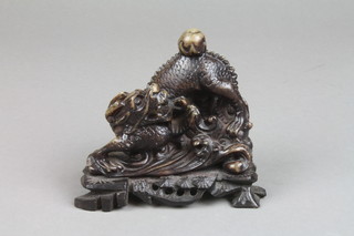 A carved soapstone figure of a dragon chasing a flaming pearl 5" 