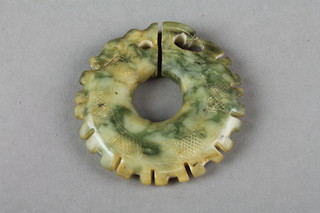 A carved jade pendant in the form of a stylised dragon 2" 