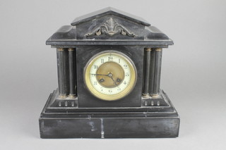 A Victorian French 8 day striking mantel clock with enamelled dial and Arabic numerals contained in a black marble architectural case 