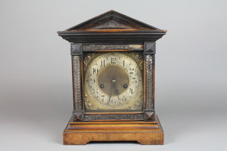 HAC, an Edwardian German striking mantel clock with square gilt dial, silvered chapter ring and Arabic numerals, contained in a carved walnut case (missing some moulding)