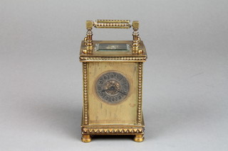 A 19th Century 8 day carriage clock with gilt dial, silver chapter ring and Roman numerals contained in a gilt metal case