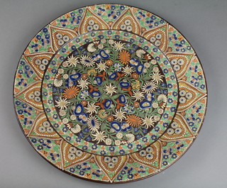 An early 20th Century Continental wall plaque decorated with scrolling flowers within a geometric border 17" 