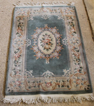A green ground and floral patterned Chinese rug 73" x 48" 