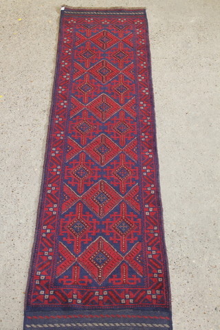 A red and blue ground Meshwani runner with 6 diamonds to the centre 102" x 25"