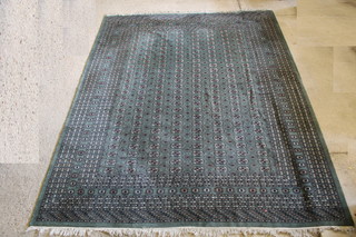 A green ground Bokhara carpet with 200 octagons to the centre within a multi row border 144" x 111" 