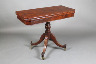 A George III mahogany tea table, raised on a turned column and tripod base 29"h x 36"w x 17 1/2"d