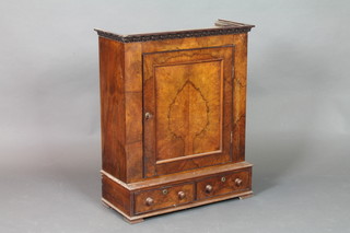 A Victorian walnut table top cabinet with moulded cornice the shelved interior enclosed by a panelled door the base fitted 2 drawers with tore handles, raised on bracket feet 30"h x 25"w x 12"d 