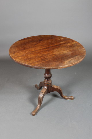 A 19th Century circular mahogany snap top tea table, raised on a turned column and tripod base with old repair to the base, 27 1/2"h x 32" diam. 