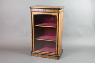 A Victorian figured walnut and ebonised pier cabinet, fitted shelves enclosed by an arched panelled door, raised on a platform base 39"h x 24 2/1"w x 14"d 