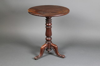A circular Victorian mahogany snap top wine table, raised on a turned column and tripod base 28 1/2"h x 23 1/2" diam. 