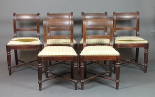 A set of 6 Georgian mahogany and bar back dining chairs with shaped mid rails and X framed stretchers, raised on turned and reeded supports 
