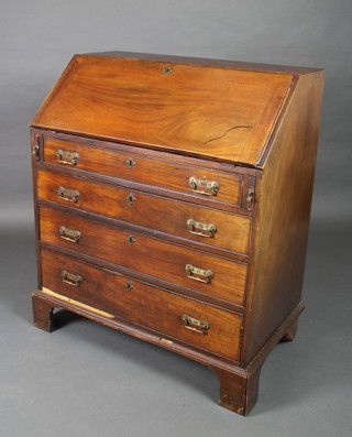 A Georgian mahogany bureau, the fall front enclosing a well fitted interior above 4 long drawers, raised on bracket feet 42"h x 36"w x 20"d 