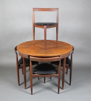 Hans Olsen.  A 1950's teak "compact" circular dining table 29"h x 42"w together with  4 bar back triangular shaped nesting chairs, by Frem Rojle Mobelfabrik,  1953, 29"h x 41 1/2" diam.